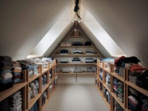 Tidy attic with folded clothes on shelves