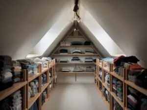 Tidy attic with folded clothes on shelves
